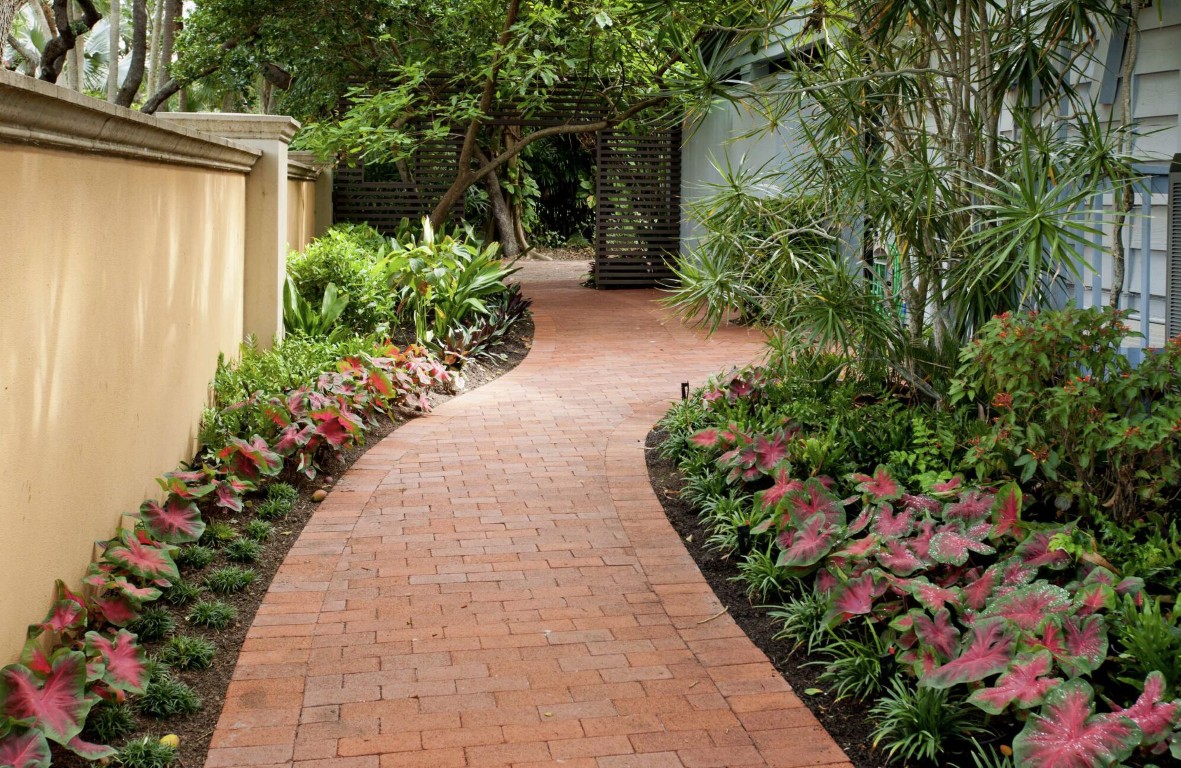 Brick paver pathway with tropical plantings in Irondequoit, NY