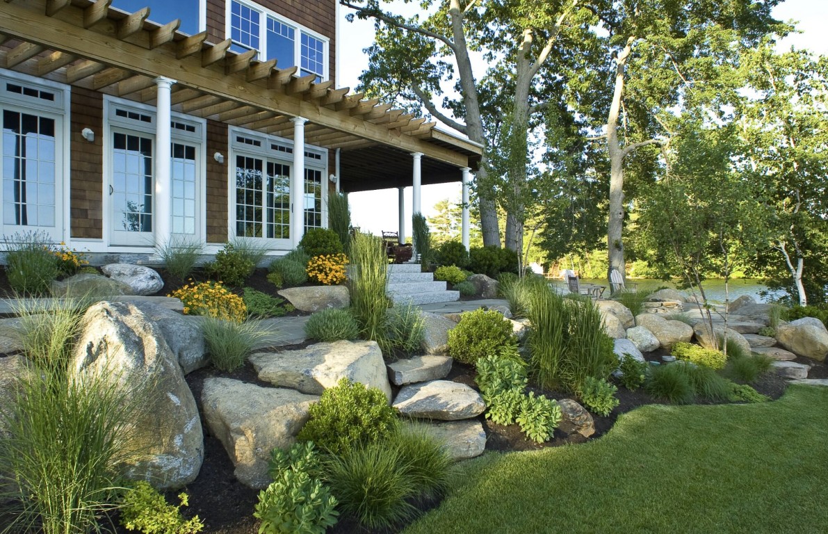 Natural stone landscaping with boulders and ornamental grasses in Irondequoit, NY